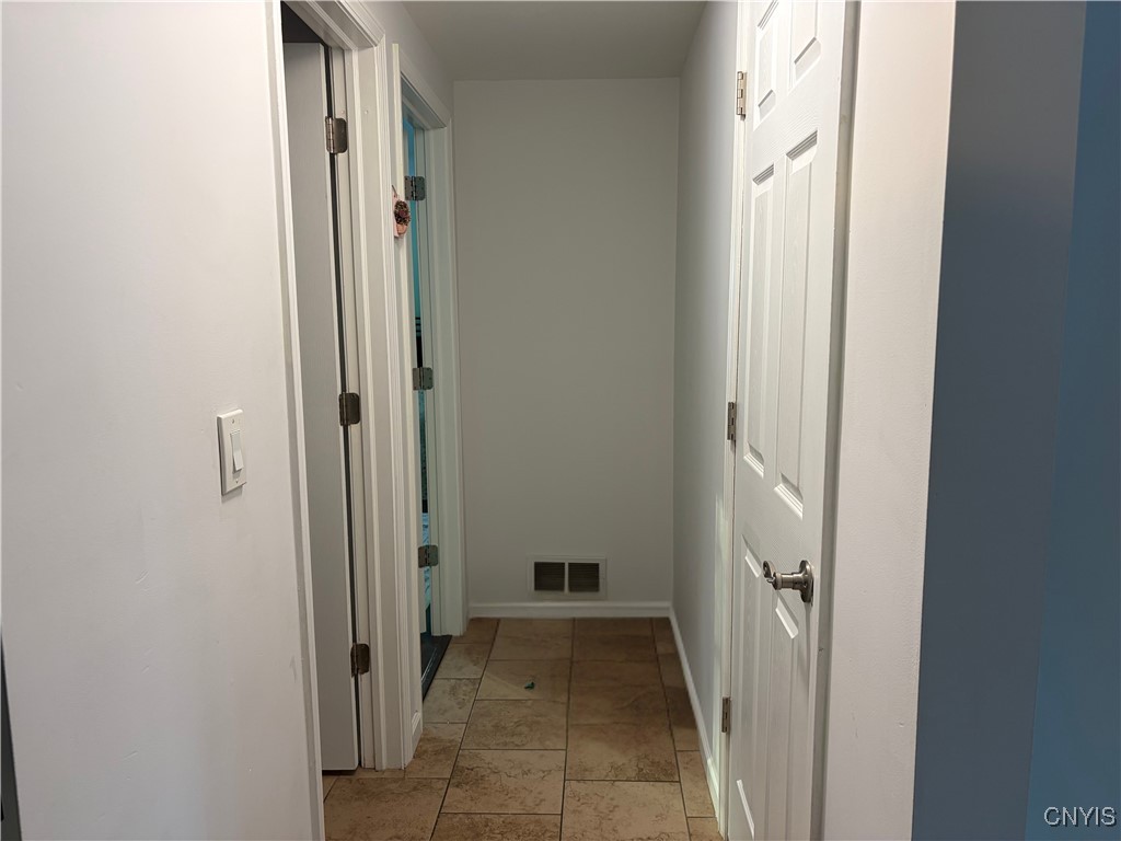 7667 Charlemont Drive Manlius, NY 13104 - Photo 13 of 33 Downstairs hallway to the first floor bedroom