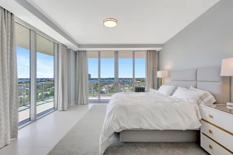 a bedroom with a large bed and a large window
