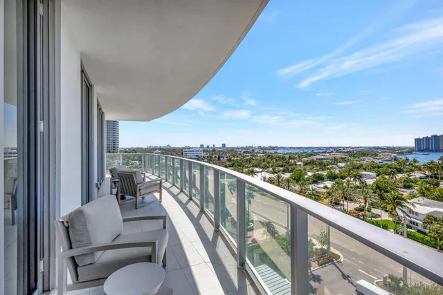 a balcony with wooden floor and city view
