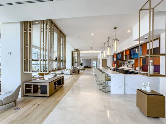 a kitchen with stainless steel appliances a stove a sink and a refrigerator
