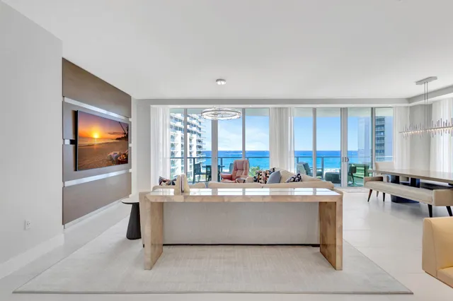 a living room with couches a coffee table and a flat screen tv