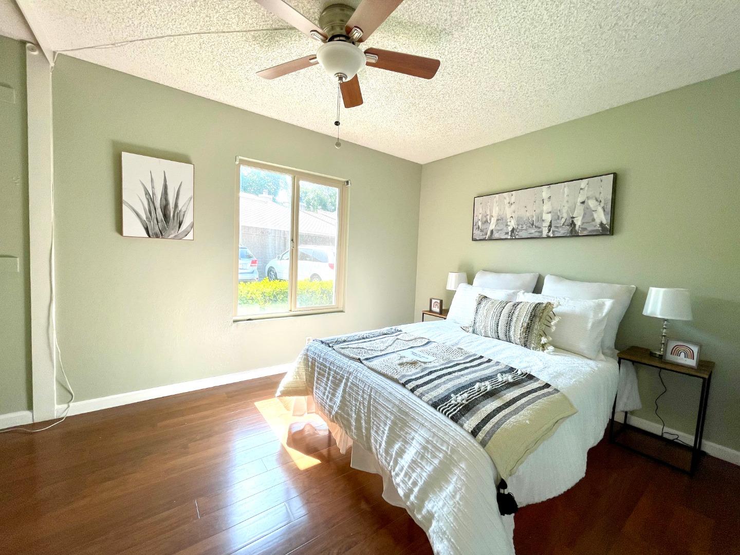 22801 Longdown Road Cupertino, CA 95014 - Photo 16 of 25 a bedroom with a bed and wooden floor