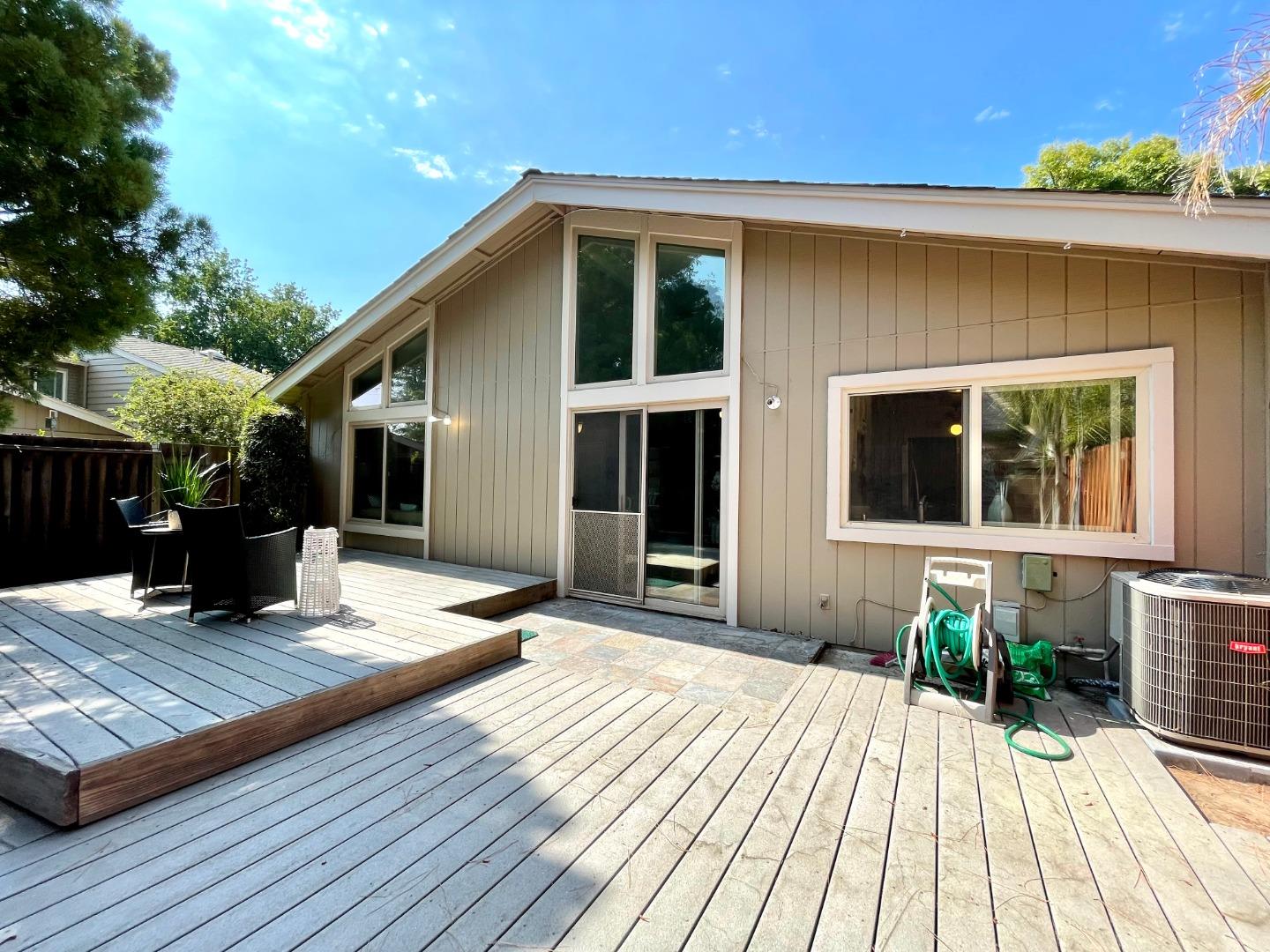 22801 Longdown Road Cupertino, CA 95014 - Photo 18 of 25 a view of a house with sitting area and wooden floor