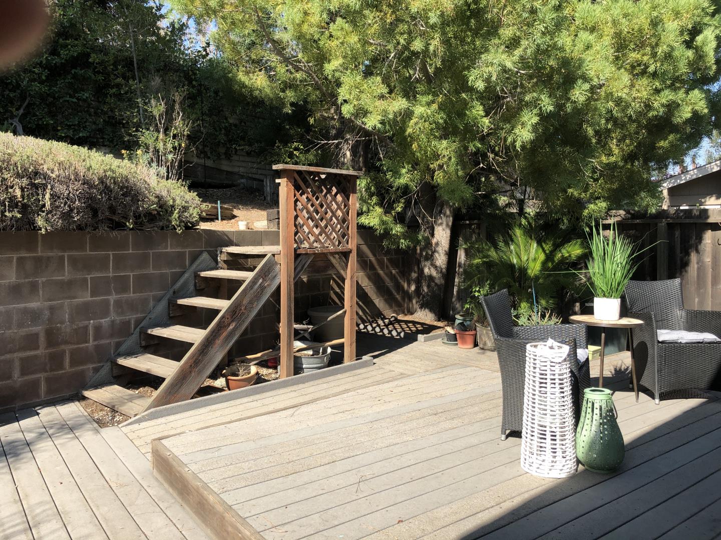 22801 Longdown Road Cupertino, CA 95014 - Photo 21 of 25 a view of a patio with table and chairs with wooden floor and fence