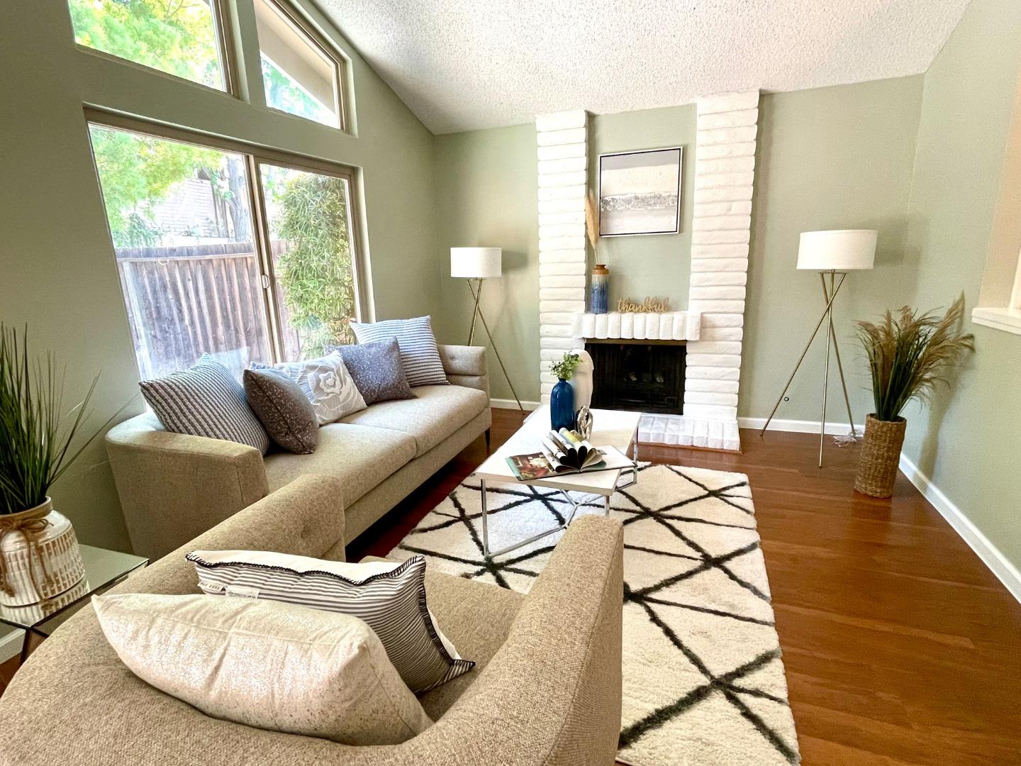 22801 Longdown Road Cupertino, CA 95014 - Photo 5 of 25 a living room with furniture and a fireplace