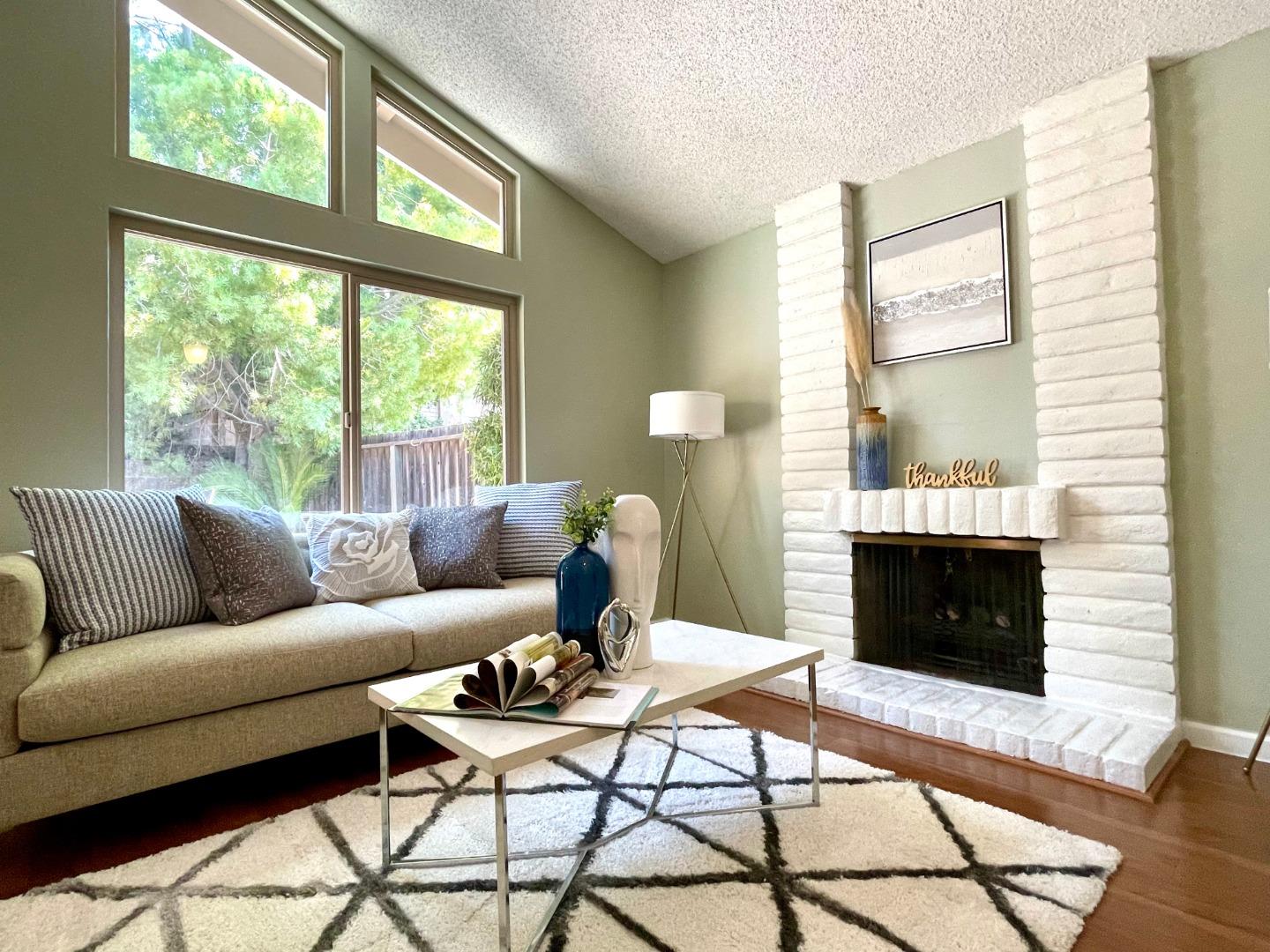 22801 Longdown Road Cupertino, CA 95014 - Photo 8 of 25 a living room with furniture a fireplace and a large window