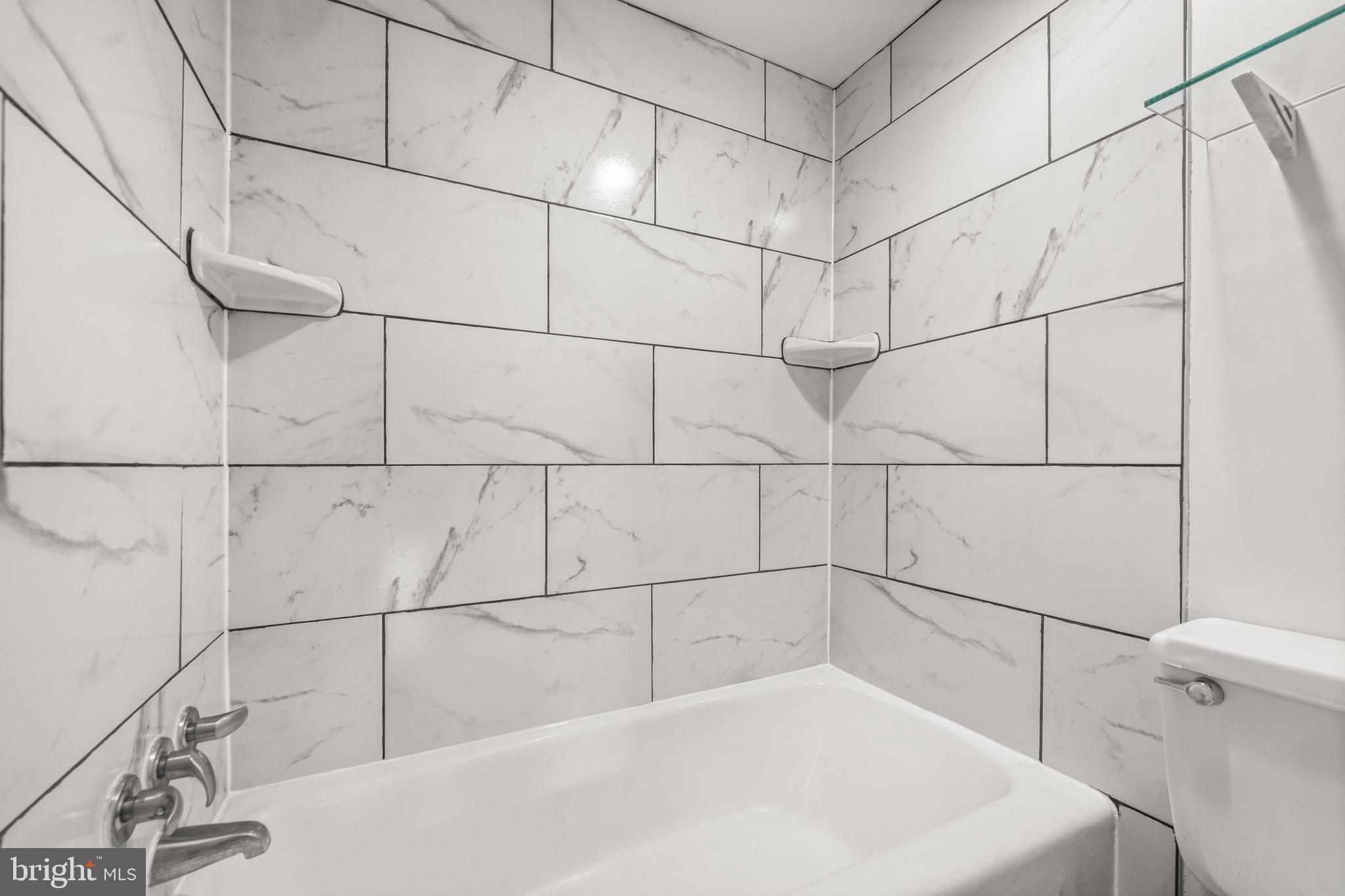 1718 P Street Northwest, Unit 316 Washington, DC 20036 - Photo 15 of 32 a bathroom with a bathtub