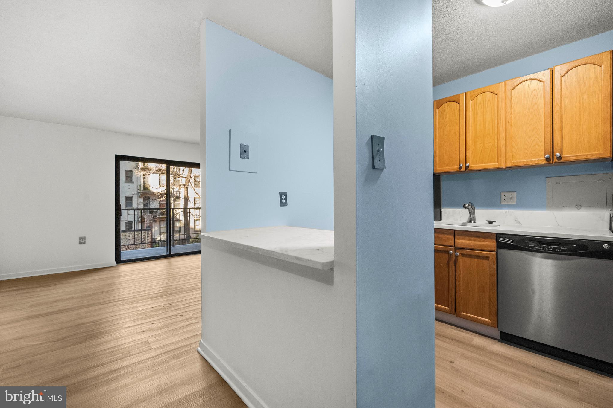 1718 P Street Northwest, Unit 316 Washington, DC 20036 - Photo 16 of 32 a kitchen with stainless steel appliances granite countertop a stove a sink and a refrigerator with wooden floors