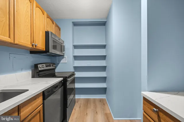 a kitchen with a sink and a stove top oven