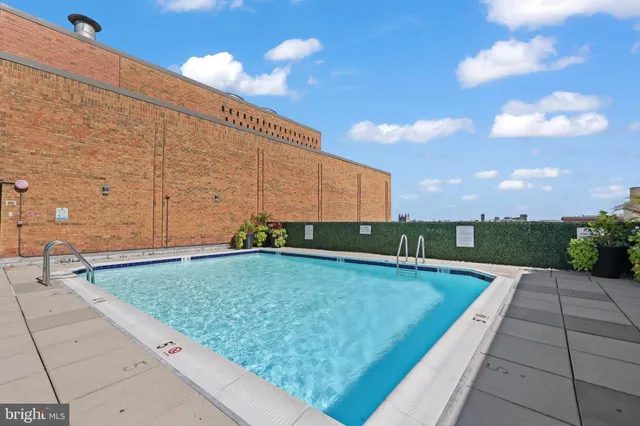 a view of swimming pool with seating space