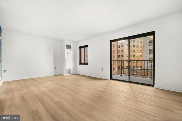 a view of an empty room with glass door