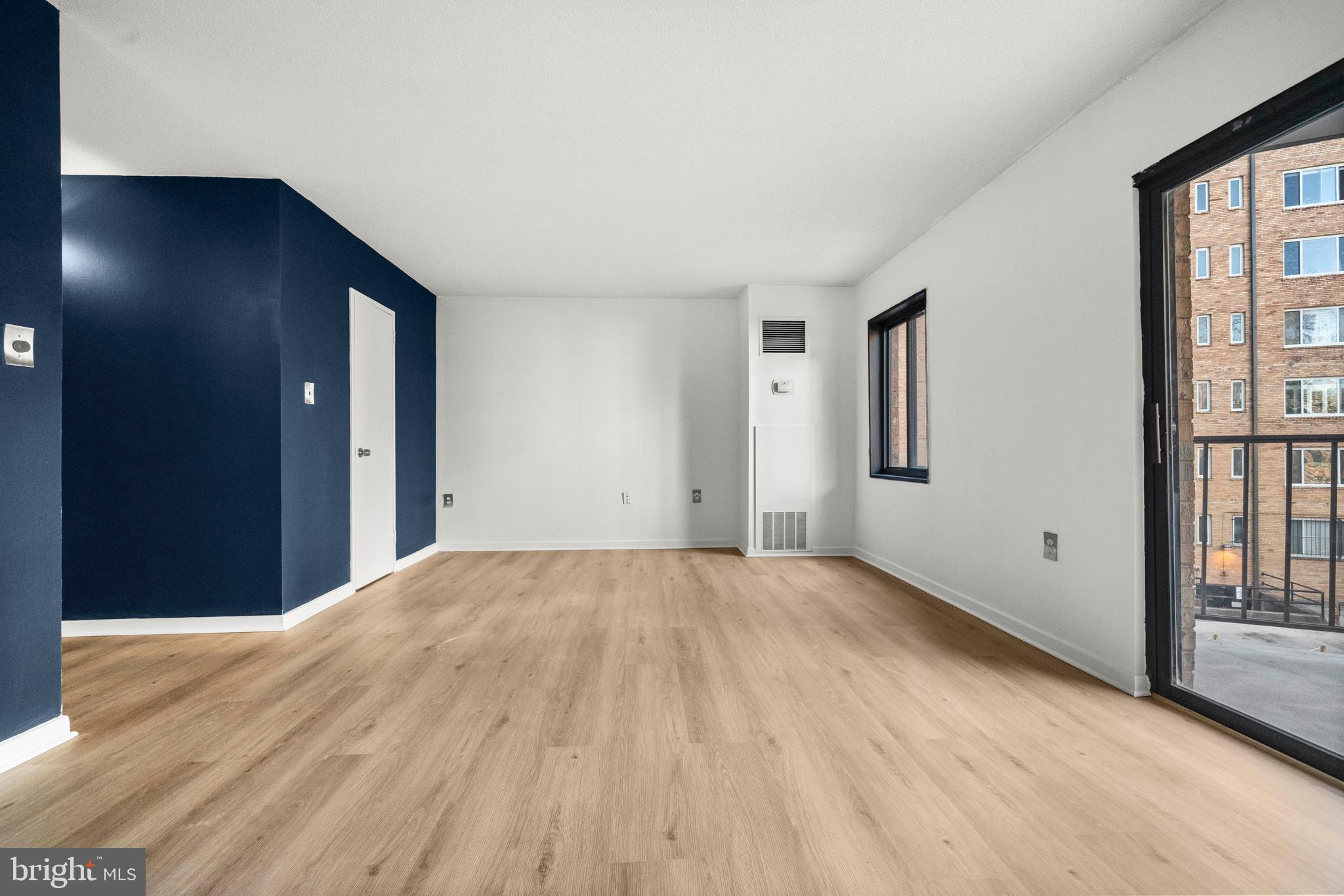 1718 P Street Northwest, Unit 316 Washington, DC 20036 - Photo 9 of 32 a view of an empty room with wooden floor and a window