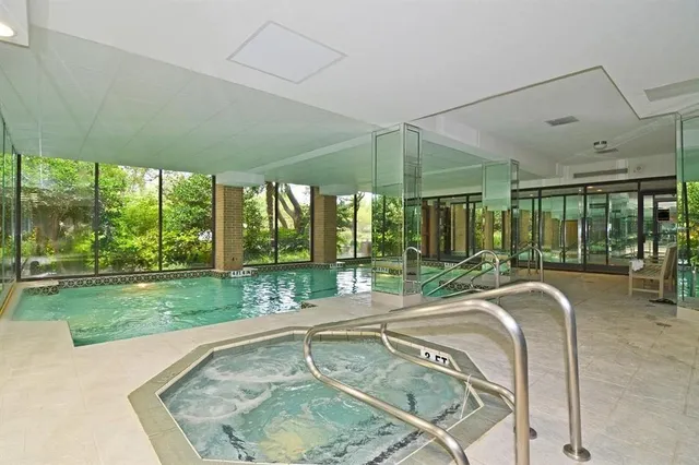 a swimming pool with outdoor seating and yard