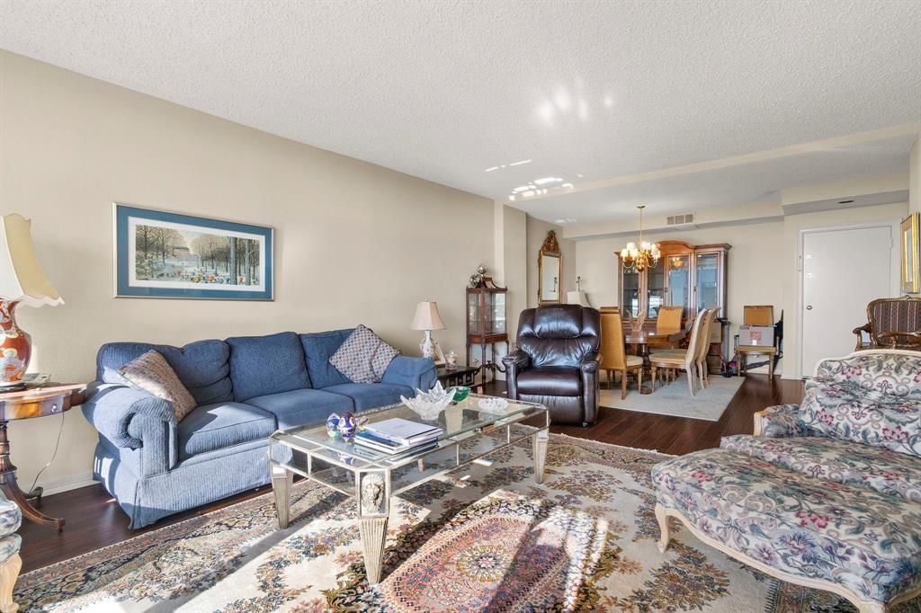 5200 Keller Springs Road, Unit 615 Dallas, TX 75248 - Photo 7 of 9 a living room with furniture and wooden floor
