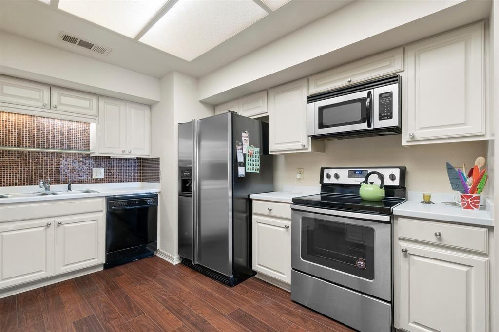5200 Keller Springs Road, Unit 615 Dallas, TX 75248 - Photo 8 of 9 a kitchen with stainless steel appliances granite countertop a stove a sink and a refrigerator
