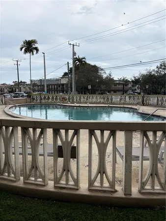 a view of swimming pool with a table and chairs