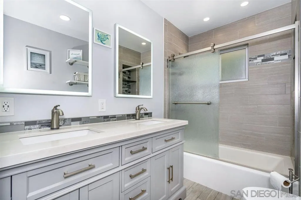 8311 Sunset Road Lakeside, CA 92040 - Photo 13 of 25 a bathroom with a granite countertop sink mirror toilet and bathtub