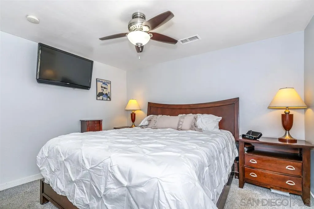 8311 Sunset Road Lakeside, CA 92040 - Photo 15 of 25 a bedroom with a bed and a flat screen tv