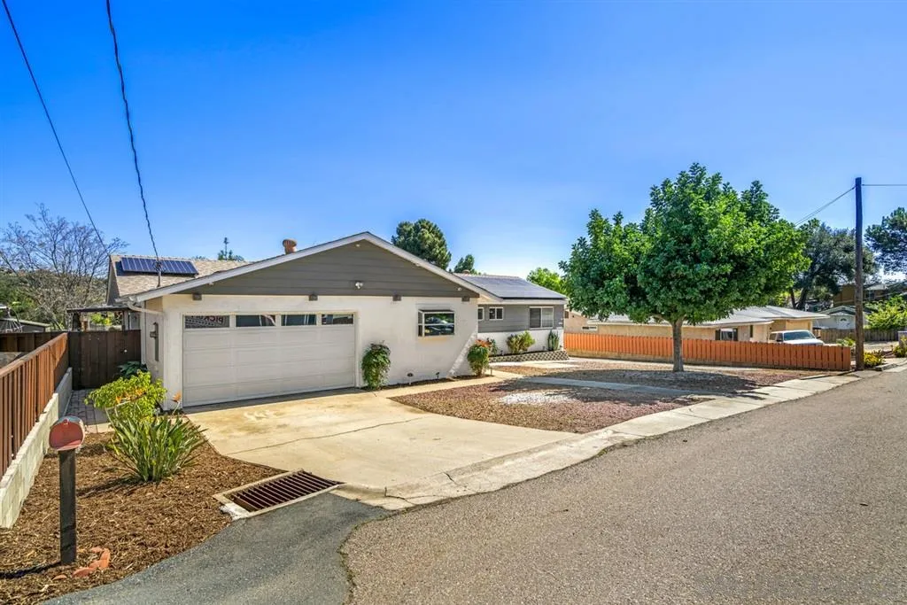 8311 Sunset Road Lakeside, CA 92040 - Photo 17 of 25 a view of a house with a yard and potted plants