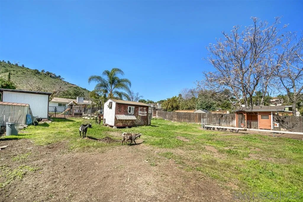 8311 Sunset Road Lakeside, CA 92040 - Photo 22 of 25 a view of a house with a big yard and large trees