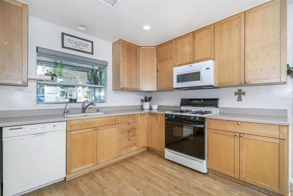 8311 Sunset Road Lakeside, CA 92040 - Photo 6 of 25 a kitchen with stainless steel appliances granite countertop a stove a sink and a microwave