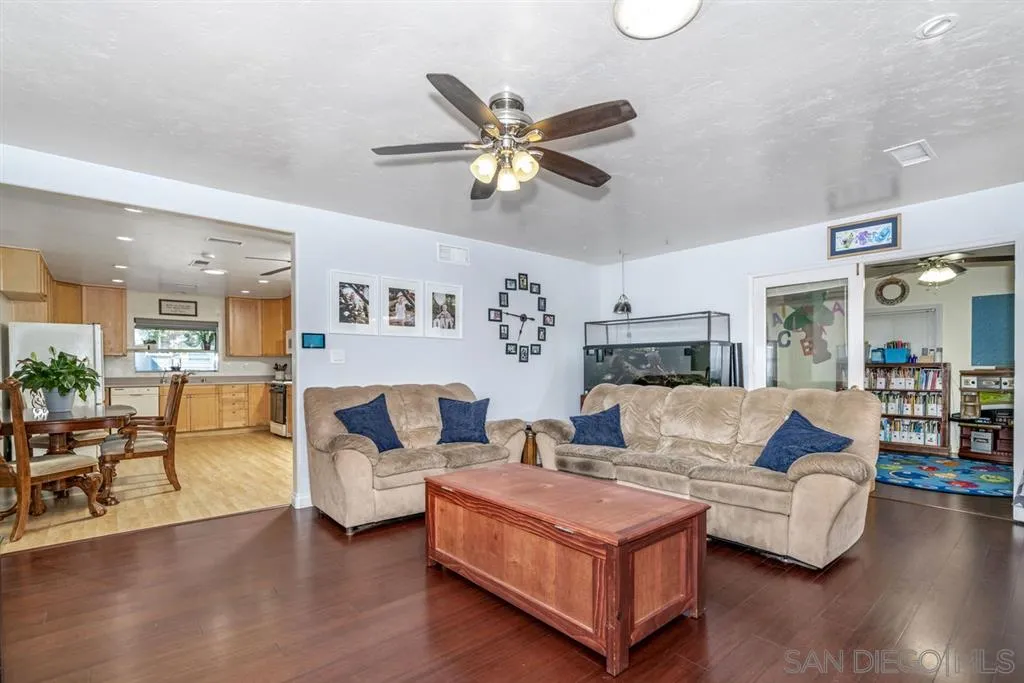8311 Sunset Road Lakeside, CA 92040 - Photo 9 of 25 a living room with furniture kitchen view and a chandelier
