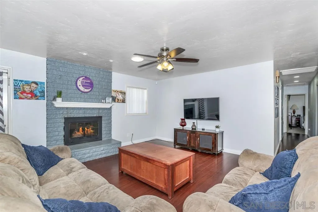 8311 Sunset Road Lakeside, CA 92040 - Photo 10 of 25 a living room with furniture fireplace and a flat screen tv