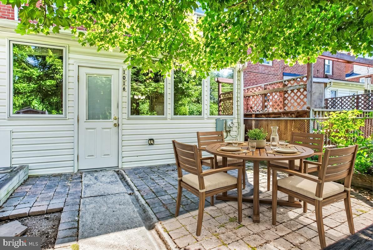 1016 Winsford Road Towson, MD 21204 - Photo 34 of 42 a view of a patio with a table and chairs next to a yard