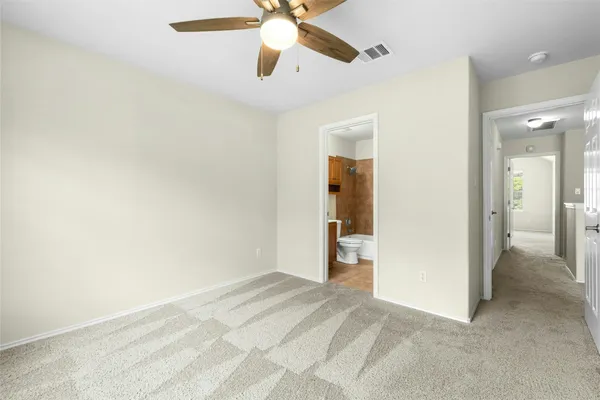 a view of a bedroom with a ceiling fan