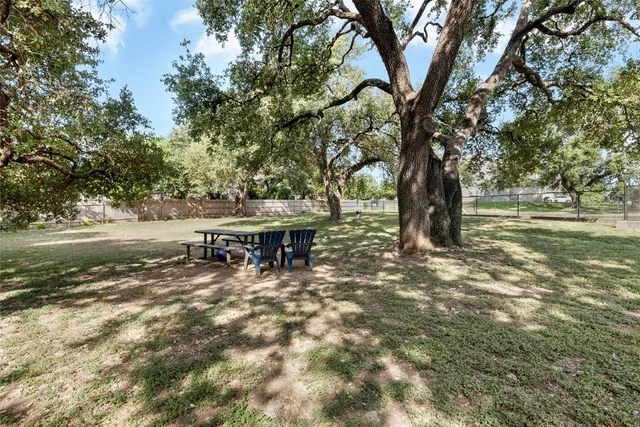 a backyard of a house with table and chairs