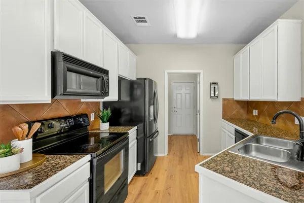 a kitchen with a sink stove and refrigerator