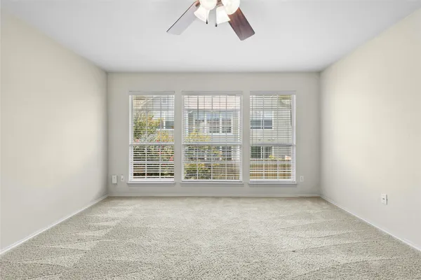 an empty room with a empty space and windows