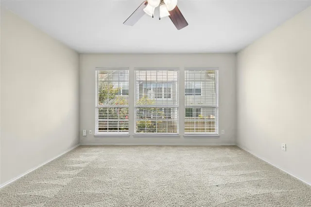 an empty room with a empty space and windows