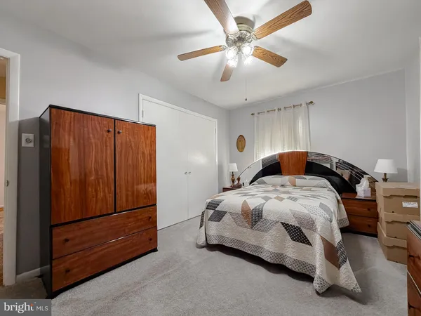 a bedroom with a bed and a television