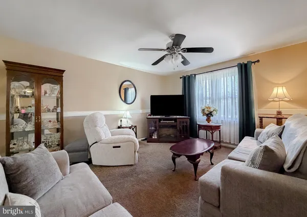 a living room with furniture a window and a flat screen tv