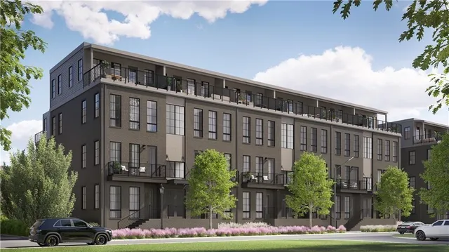 a front view of a building with street view and trees