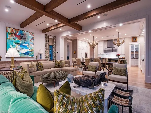 a kitchen with stainless steel appliances granite countertop a sink a counter space and living room view