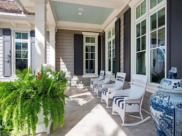 a view of a patio with table and chairs and potted plants