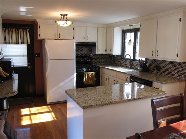 451 Lepes Road Somerset, MA 02726 - Photo 8 of 10 a kitchen with kitchen island granite countertop a sink a center island stainless steel appliances and cabinets