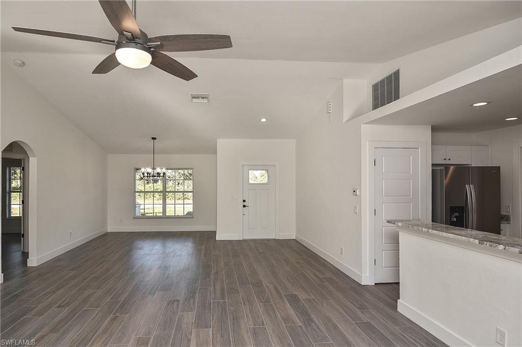 785 Homestead Road South Lehigh Acres, FL 33974 - Photo 3 of 49 wooden floor in an empty room with a window