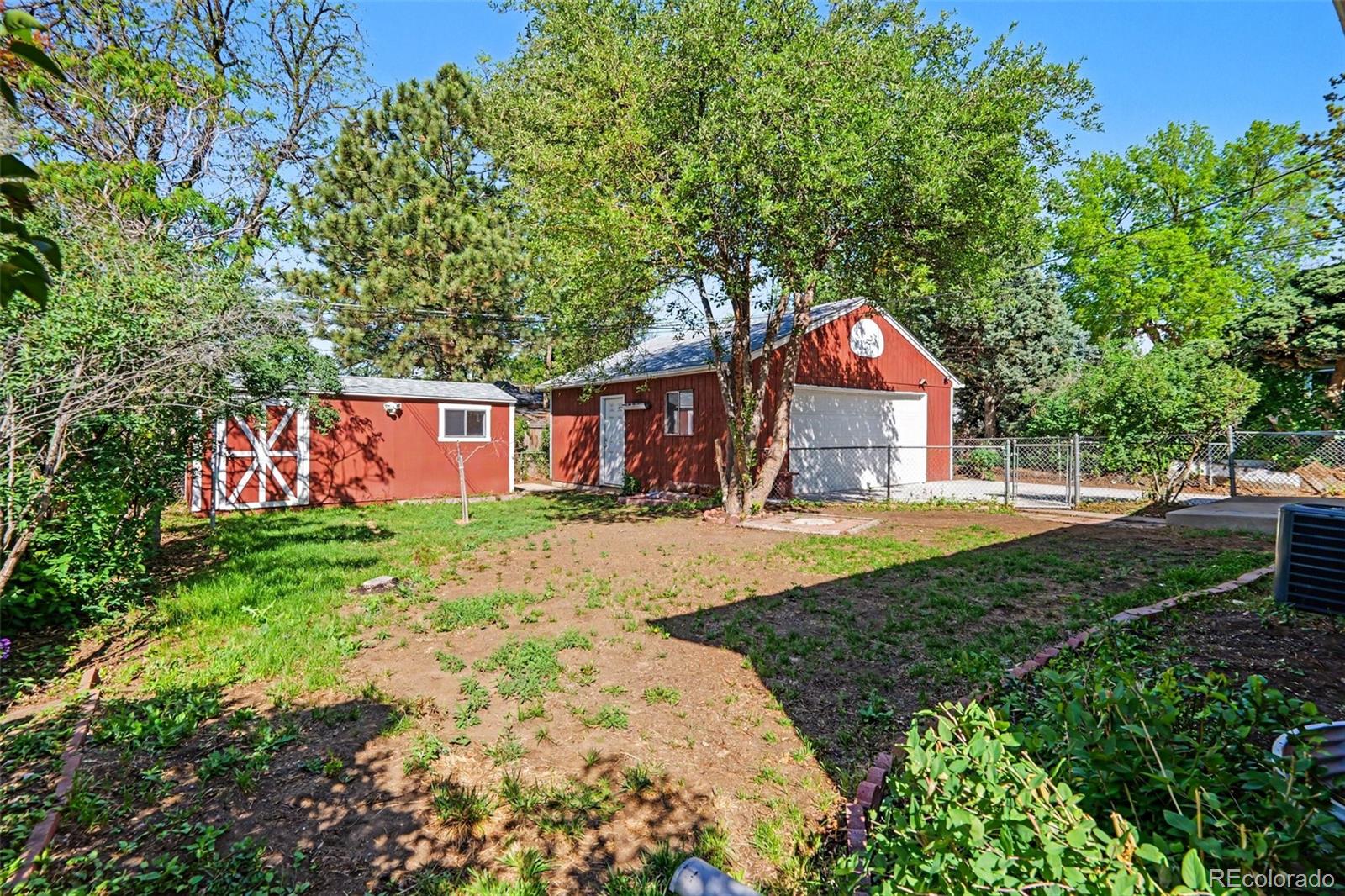 3217 South Stuart Street Denver, CO 80236 - Photo 4 of 29 a front view of a house with garden