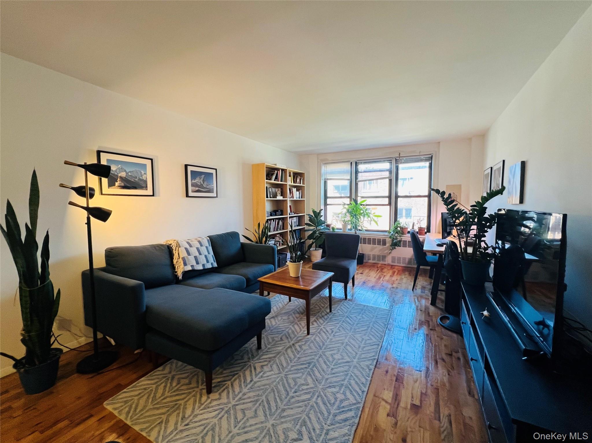 58-03 Calloway Street, Unit 3MM Queens, NY 11368 - Photo 6 of 9 a living room with furniture and a flat screen tv
