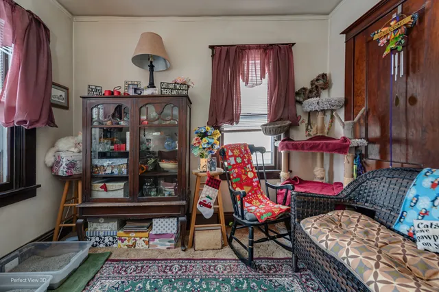 a living room with lots of furniture and baby crib