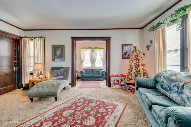 a bedroom with furniture and a large window