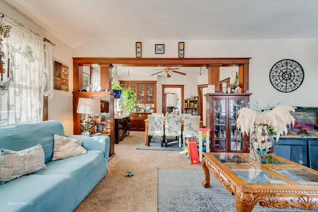 a living room with furniture a clock and a window