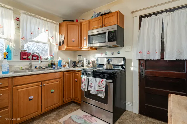 a kitchen with stainless steel appliances granite countertop a stove top oven microwave and cabinets
