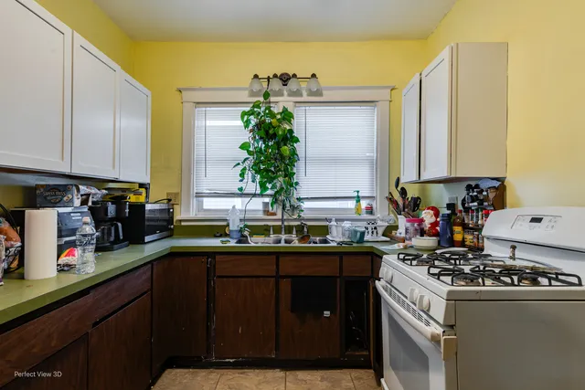 a kitchen with a sink stove and cabinets