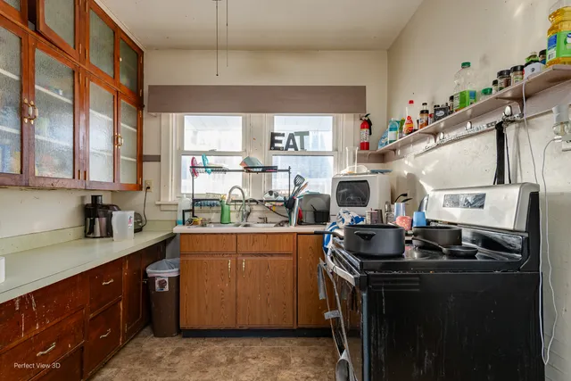 a kitchen that has a lot of cabinets in it