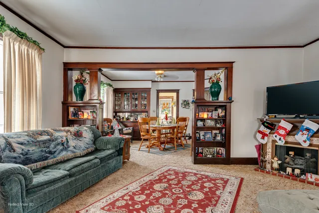 a living room with furniture a flat screen tv and a window