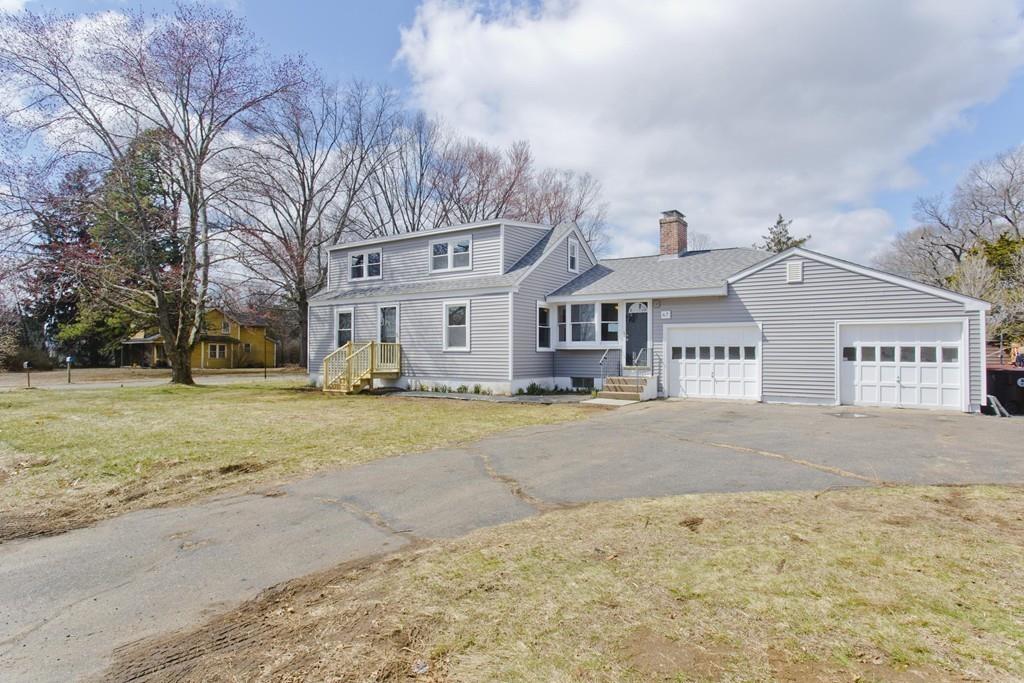 a front view of a house with a yard covered in snow